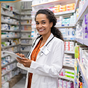 Young mixed race pharmacist using digital tablet