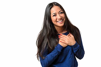Young woman with her hands over her heart.