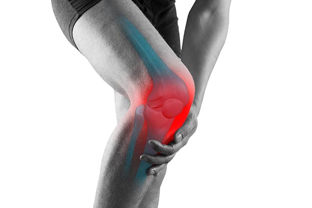 Legs wearing black biker shorts with red and blue knee x ray light