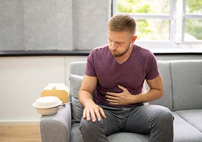 Man burping after eating fast food